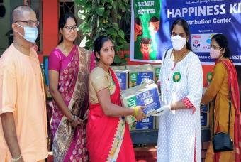 Parents visit the distribution centre to collect the happiness kits