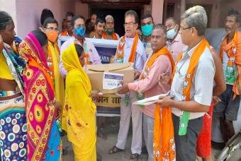 Poor people patiently wait for the relief supplies