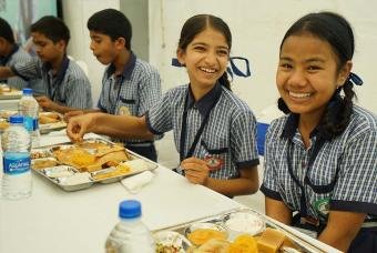 Schoolchildren enjoying the meals served at the event.