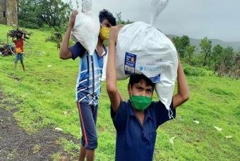 Friends begin their journey back home after collecting their grocery kits
