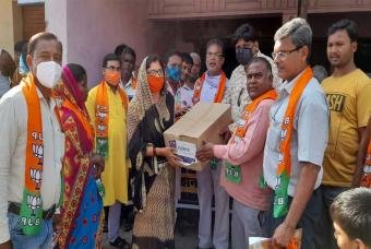 Volunteers help organize the crowd that has gathered at the distribution location