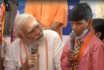 PM listens keenly to a beneficiary singing