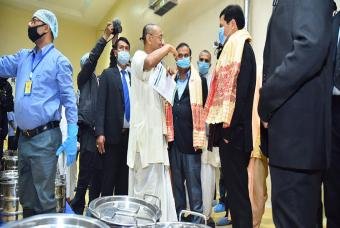 Dignitaries on a tour of kitchen facilities