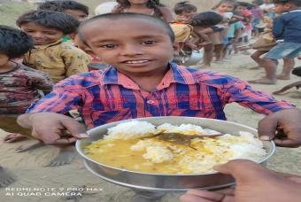 Handing over healthy meals to child as others line up